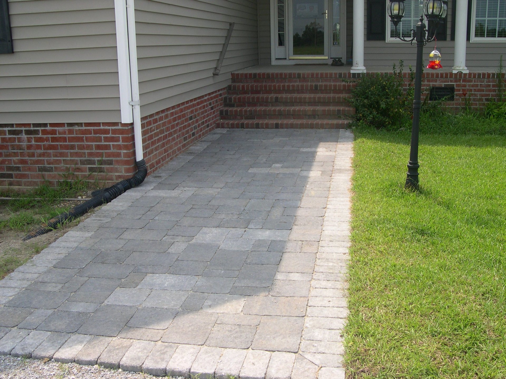 Walk way pavers to the front steps of a house.